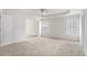 Spacious bedroom featuring carpet, a tray ceiling with fan, and natural light from two windows at 7280 Wright Dr, Atlanta, GA 30349