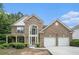 Charming brick home with a two-car garage and landscaped front yard offers great curb appeal at 7280 Wright Dr, Atlanta, GA 30349