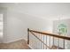 Hallway with stairs leading to the entryway, chandelier, and natural light at 7280 Wright Dr, Atlanta, GA 30349