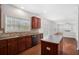 Open-concept kitchen with wooden cabinets, island, and view into a cozy living space, great for Gathering gatherings at 7280 Wright Dr, Atlanta, GA 30349