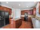 Well-equipped kitchen with wooden cabinets, island, and tile backsplash, offering ample storage space at 7280 Wright Dr, Atlanta, GA 30349