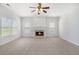 Inviting living room with neutral carpet, fireplace, and multiple windows offering plenty of natural light at 7280 Wright Dr, Atlanta, GA 30349