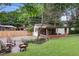 Backyard with patio, a fire pit, mature trees, and a landscaped garden at 96 Dartmouth Ave, Avondale Estates, GA 30002