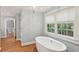 Freestanding bathtub with windows offering natural light and backyard views at 96 Dartmouth Ave, Avondale Estates, GA 30002