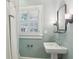 Bathroom featuring pedestal sink, shuttered window, and decorative mirror at 96 Dartmouth Ave, Avondale Estates, GA 30002