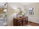 Dining room with glass table, modern light fixture, and adjacent wood cabinet with display case at 96 Dartmouth Ave, Avondale Estates, GA 30002