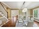 Stylish dining room with a staircase, hardwood floors, and ample natural light, providing an inviting ambiance at 96 Dartmouth Ave, Avondale Estates, GA 30002