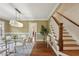 Elegant dining room with hardwood floors, designer wallpaper, and staircase, perfect for hosting gatherings at 96 Dartmouth Ave, Avondale Estates, GA 30002