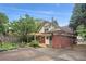 Charming brick home featuring a pergola-covered porch and gated driveway at 96 Dartmouth Ave, Avondale Estates, GA 30002