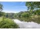 A serene lake view with lush greenery and reflections on the water at 96 Dartmouth Ave, Avondale Estates, GA 30002