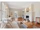Spacious living room featuring a decorative fireplace, hardwood floors, and abundant natural light at 96 Dartmouth Ave, Avondale Estates, GA 30002