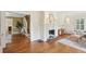Living room featuring hardwood floors, fireplace, stairs, and views into dining room at 96 Dartmouth Ave, Avondale Estates, GA 30002