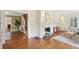 Open-concept living room with hardwood flooring, a fireplace, staircase, and seamless transitions to other rooms at 96 Dartmouth Ave, Avondale Estates, GA 30002