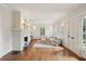 Well-lit living room with hardwood floors, a fireplace, plantation shutters, and ample space at 96 Dartmouth Ave, Avondale Estates, GA 30002