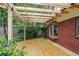 New wooden patio with brick siding and a wooden pergola, perfect for entertaining at 96 Dartmouth Ave, Avondale Estates, GA 30002