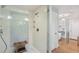 Modern walk-in shower with tiled walls, a built-in niche, and a wooden stool at 96 Dartmouth Ave, Avondale Estates, GA 30002