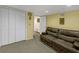 Finished basement with carpet, storage closet and living area at 222 Mossy Pl, Alpharetta, GA 30005