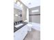 Bathroom with a white vanity, granite counters, and tiled shower at 222 Mossy Pl, Alpharetta, GA 30005