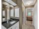 Bathroom vanity with granite countertop, white cabinets, and wall mirror at 222 Mossy Pl, Alpharetta, GA 30005