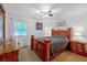 Bedroom features a bed, ceiling fan, natural light, and wooden furniture at 222 Mossy Pl, Alpharetta, GA 30005