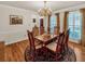 Traditional dining room featuring hardwood floors, a large table, and stylish decor at 222 Mossy Pl, Alpharetta, GA 30005