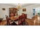 Formal dining room with hardwood floors, chandelier, and ample seating at 222 Mossy Pl, Alpharetta, GA 30005
