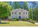 Charming two-story home with lush landscaping and a well-manicured lawn at 222 Mossy Pl, Alpharetta, GA 30005