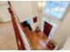 Bright foyer area with wood floors, chandelier, staircase and dark wood front door at 222 Mossy Pl, Alpharetta, GA 30005