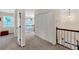 Hallway featuring carpet, double closet, and windows for natural light at 222 Mossy Pl, Alpharetta, GA 30005
