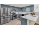 Modern kitchen with stainless steel appliances, granite countertops, and stylish backsplash at 222 Mossy Pl, Alpharetta, GA 30005