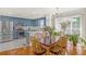 Spacious kitchen with stainless steel appliances, open to a dining area with a chandelier at 222 Mossy Pl, Alpharetta, GA 30005