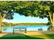 Picturesque lake view with benches under shady trees, offering a serene outdoor space at 222 Mossy Pl, Alpharetta, GA 30005