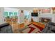 Cozy living room with a fireplace, hardwood floors, and access to a bright sunroom at 222 Mossy Pl, Alpharetta, GA 30005