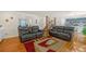 Inviting living room with hardwood floors and plush seating, open to the kitchen and staircase at 222 Mossy Pl, Alpharetta, GA 30005