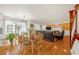 Open-concept living space with a dining area, fireplace, and sliding doors to a sunroom at 222 Mossy Pl, Alpharetta, GA 30005