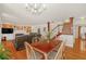 Bright living space with hardwood floors, built-in shelving, a fireplace, and access to a dining area at 222 Mossy Pl, Alpharetta, GA 30005