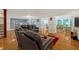 Spacious living room connecting to the kitchen and sunroom, featuring hardwood floors and comfortable seating at 222 Mossy Pl, Alpharetta, GA 30005