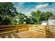 Wooden back deck with wooden railing overlooking green backyard at 2276 Sutton Se St, Atlanta, GA 30317