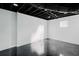 The basement with an exposed painted ceiling, polished concrete floors, and natural light at 2276 Sutton Se St, Atlanta, GA 30317