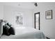 Bright bedroom with a ceiling fan, large window, and minimalist decor at 2276 Sutton Se St, Atlanta, GA 30317