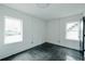 A modern bedroom featuring bright white walls and trim, black polished concrete floor, and natural light at 2276 Sutton Se St, Atlanta, GA 30317