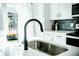 Close-up shot of a modern kitchen featuring white countertops and a black faucet at 2276 Sutton Se St, Atlanta, GA 30317