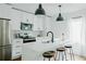 Modern kitchen with stainless steel appliances, white cabinets, island seating and pendant lighting at 2276 Sutton Se St, Atlanta, GA 30317