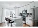 A modern, all-white kitchen featuring a stainless steel fridge and black accents at 2276 Sutton Se St, Atlanta, GA 30317