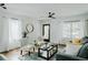 Bright living room features hardwood floors, large windows, and stylish decor for a cozy atmosphere at 2276 Sutton Se St, Atlanta, GA 30317