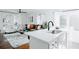 Open-concept living room with kitchen island and barstool seating with a gray sofa at 2276 Sutton Se St, Atlanta, GA 30317