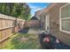 Backyard with patio, a small grassy area, and lush landscaping along the fence line at 331 Franklin Ln, Acworth, GA 30102