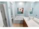 Well-lit bathroom featuring double sinks, a soaking tub, and neutral blue paint at 331 Franklin Ln, Acworth, GA 30102