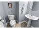 Charming powder room with gray walls, tile floors, and decorative towel with matching artwork at 331 Franklin Ln, Acworth, GA 30102