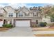 Inviting townhome showcasing a two-car garage, tidy landscaping, and a welcoming facade at 331 Franklin Ln, Acworth, GA 30102